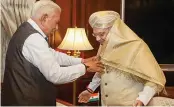  ?? —PTI ?? Karnataka governor Vajubhai Vala presents a shawl to Union home minister Amit Shah during a meeting in New Delhi on Tuesday.