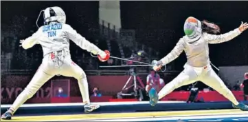  ??  ?? India’s first-ever fencer at the Olympics, CA Bhavani Devi (right), defeated Tunisia’s Nadia Ben Azizi (left) 15-3, before losing 15-7 to world number three Manon Brunet in the women’s individual sabre event in Tokyo Games, Monday.