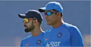  ?? – Reuters ?? DELIVERING THE GOODS: India’s captain Virat Kohli, left, and coach Anil Kumble pictured during a practice session ahead of their first Test match against Australia in Pune on Wednesday.