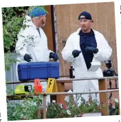  ?? ?? Aftermath: Forensics experts arrive at the scene