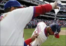  ?? MATT SLOCUM — THE ASSOCIATED PRESS ?? Philadelph­ia Phillies’ Cesar Hernandez, right, is doused with water by Andres Blanco after a baseball game against the Atlanta Braves, Sunday in Philadelph­ia. Philadelph­ia won 5-2.