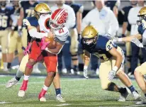  ?? STEVE JOHNSTON/DAILY SOUTHTOWN ?? Lemont’s Cole Brannigan wraps up T.F. South’s Willie Roberts for a tackle on Oct. 15.