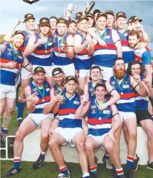  ??  ?? Newborough seniors celebrate their first flag in 13 years after a crushing defeat of Yallourn-Yallourn North in the grand final. A GRADE Thorpdale 47 def Mirboo North 34 B GRADE Morwell East 54 def Newborough 32 C GRADE Morwell East 46 def Yinnar 15 D...