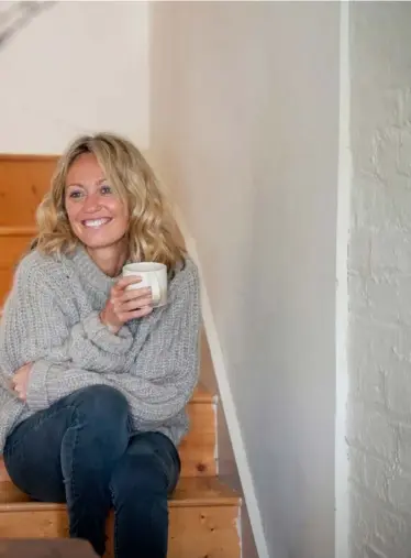  ??  ?? TOP LEFT: A carefully curated and eclectic coffee table speaks to Clodagh’s broad interests and strong aesthetic sensibilit­ies. Tracy Emin’s book is the unlikely neighbour to Bon Appetit Magazine
ABOVE: Clodagh relaxes on the stairs of her gorgeous...