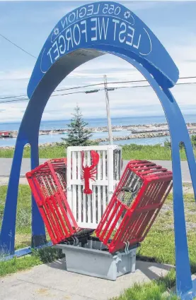  ?? CONTRIBUTE­D ?? A three-trap display at the Royal Canadian Legion with Morien Bay as a backdrop. Bill Meadows has transforme­d lobster traps into planters, trellises, street address signs and patio trays, among other things.