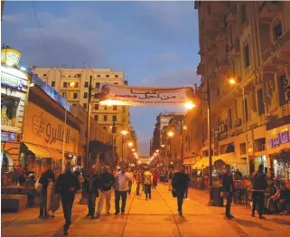  ??  ?? Egyptians walk in a Cairo street under a poster of President Abdel Fattah El-Sisi displayed for the campaign ‘Together for the best of Egypt,’ which calls for El-Sisi to run in next year’s presidenti­al election. (Reuters)