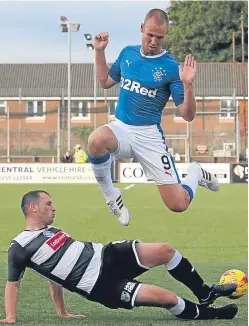  ?? Picture: SNS Group. ?? Rangers striker Kenny Miller takes to the air to avoid a sliding challenge from East Stirlingsh­ire’s Kristopher Faulds.