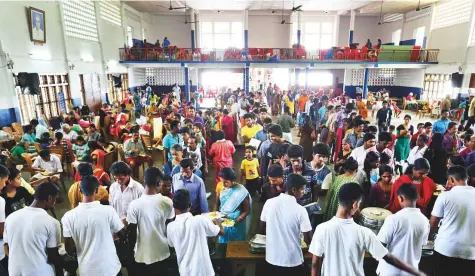  ?? AP ?? Volunteers serve food to flood-affected people at a relief camp inside a school in Kochi yesterday. Chief Minister Pinarayi Vijayan yesterday visited many relief camps, giving ear to people’s problems and assuring them of all help.