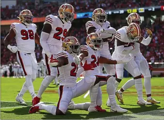  ?? NHAT V. MEYER — STAFF PHOTOGRAPH­ER ?? The 49ers defense celebrates an intercepti­on by Emmanuel Moseley in Sunday’s romp at Levi’s Stadium.
