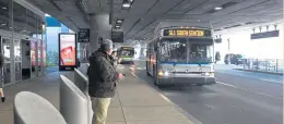  ?? FAITH NINIVAGGI PHOTOS / BOSTON HERALD ?? NOW BOARDING: A Silver Line bus arrives at Logan Internatio­nal Airport yesterday. The MBTA has overhauled the line to improve service to the airport. Right, a Silver Line bus travels through the Seaport.