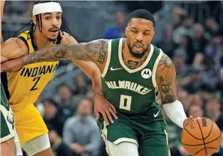  ?? MORRY GASH/THE ASSOCIATED PRESS ?? The Milwaukee Bucks’ Damian Lillard gets past Indiana Pacers’ Andrew Nembhard on Sunday during the first half of Game 1 of a first-round playoff series in Milwaukee.