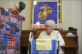  ?? LAUREN A. LITTLE - MEDIANEWS GROUP ?? Pam Kubczak of the Women’s Marine’s Associatio­n presents a Marines blanket to Pauline Klinger Rohrbach as they celebrate Pauline’s 97th birthday and her Marine Corps service during World War II.