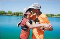  ?? AP ?? Jacky Hunt-Broersma kisses her husband, Edwin Broersma, after finishing her 102nd consecutiv­e marathon last Thursday.