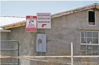  ?? MATT DAHLSEID/THE NEW MEXICAN ?? Signs at a Chamita house where a man died in a shooting warn against trespasser­s, with one reading ‘Violators will be shot. Survivors will be shot again!!!’