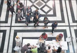  ?? AFP ?? (Above) People queue at a polling station in Marseille, southern France; (right) French nationals at a booth in Puducherry on Sunday.