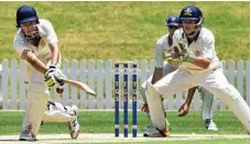  ?? PHOTOS: IAN SPENCE ?? GOOD HIT OUT: Downlands’ Matthew Rhode swings at the ball during their match against Grammar.