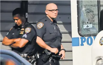  ?? SETH WENIG, AP ?? Officers stand near the vehicle, its window shattered, in which a fellow officer was fatally shot.