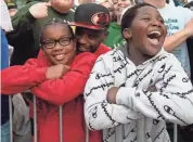  ??  ?? Zamir Brimley, left, and Kalib Hayes enjoy the game outside the arena Sunday.