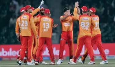  ??  ?? ↑
Islamabad United players celebrate after their victory over Lahore Qalandars in a PSL match at the Gaddafi Stadium in Lahore on Sunday.