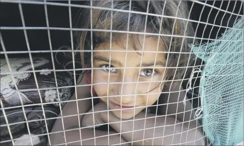  ?? Picture: Getty ?? A Syrian refugee girl shelters at a refugee camp south of Beirut after her family fled to Lebanon