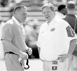  ?? JOHN RAOUX/ASSOCIATED PRESS ?? Last year the media picked Butch Jones, left, and Tennessee to win the SEC East, but the division title wound up going to Jim McElwain and UF for the second straight season.