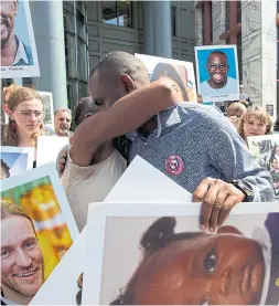  ?? THE ASSOCIATED PRESS FILE PHOTO ?? Paul Njoroge, centre, attends a vigil in Washington on the six-month anniversar­y of the Ethiopian Airlines Flight 302 crash.