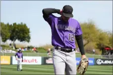  ?? ROSS D. FRANKLIN — THE ASSOCIATED PRESS ?? Injured Rockies left fielder Sean Bouchard walks back to the dugout during the first inning of Wednesday’s spring training game against the Angels in Tempe, Ariz.