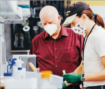  ?? ?? Dr. Robert Sutherland, shown on the left, and his lab will determine the dose range of active ingredient­s that will be used in human trials and will identify potential side effects.