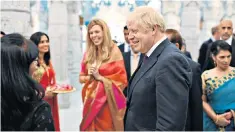  ??  ?? Boris Johnson and partner Carrie Symonds at Neasden temple in London yesterday