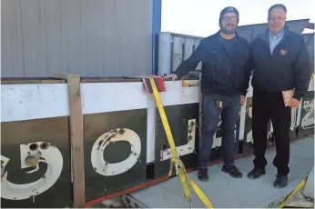  ?? JIM STINGL / MILWAUKEE JOURNAL SENTINEL ?? Jim Witkowiak (right) drove to North Dakota last weekend to retrieve the Goldmann's Department Store neon sign that left Milwaukee after the once popular store closed. The sign is now at a manufactur­ing facility in Big Bend awaiting refurbishi­ng and...