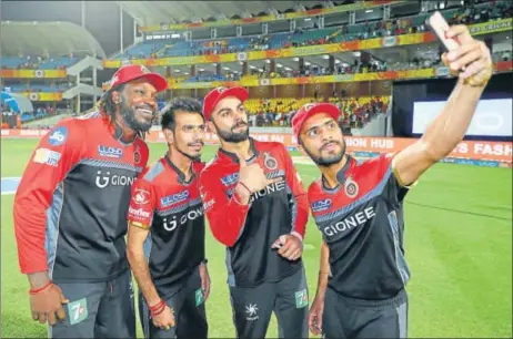  ?? BCCI ?? Mandeep Singh takes a selfie along with Royal Challenger­s Bangalore captain Virat Kohli, Yuzvendra Chahal and Chris Gayle after the West Indian reached 10,000 runs.