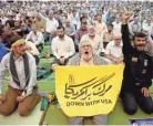  ?? ABEDIN TAHERKENAR­EH/EPA-EFE ?? An Iranian man holds an anti-US placard during Friday prayers at a mosque in Tehran. Iran said Friday it had seized a British oil tanker for non-compliance with maritime law.