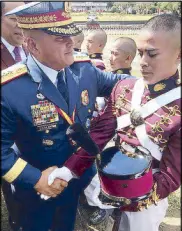  ??  ?? Dela Rosa is seen congratula­ting his son, Rock, a PNPA student during an event in the school last year.