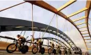  ?? Photograph: Tim de Waele/Getty Images ?? The Jumbo-Visma team cross a bridge during the opening time trail in Utrecht.