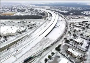  ?? ?? The Associated Press
An icy mix covers Highway 114 on Monday, in Roanoke, Texas.