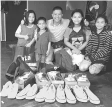  ??  ?? Wan and Isah’s happy children posing with the school uniforms.