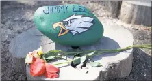  ?? STAFF PHOTO BY DANDAN ZOU ?? A rock dedicated to Jimmy Lee lies on a tree stump in a small memorial garden on Feb. 24 at Jude House. Lee died from an overdose in February after being released from Jude House.