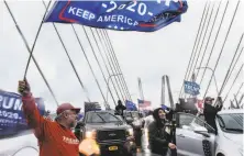  ?? Stephanie Keith / Getty Images ?? Cars block traffic on the Gov. Mario M. Cuomo Bridge on Sunday in Tarrytown, N. Y. Trump supporters coordinate­d large caravans across the country, including one in the North Bay.