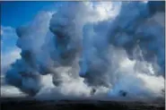  ?? JAE C. HONG — THE ASSOCIATED PRESS ?? In this file photo, plumes of steam rise as lava enters the ocean near Pahoa, Hawaii.