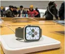  ?? /Reuters/File ?? Smart time management: An Apple smartwatch is displayed as customers visit the Apple store in New York the day after Christmas 2023.