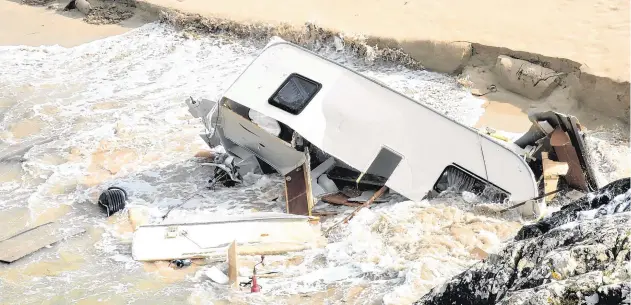  ?? PHOTO: PAUL MEALEY ?? Tragedy: The scene in Co Galway where a Swiss tourist died when her caravan was blown into the sea by Storm Ali
