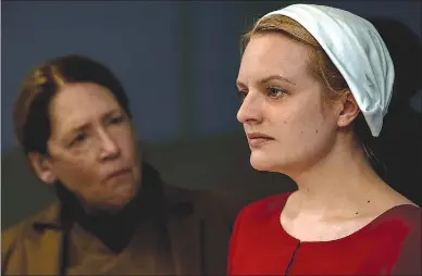  ?? Associated Press photo ?? This image released by Hulu shows Ann Dowd, left, and Elisabeth Moss in a scene from the series “The Handmaid's Tale.”