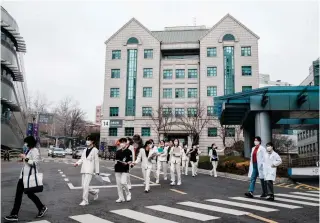  ?? AFP PHOTO ?? TIME OFF
Medical workers walk outside a hospital in South Korea’s capital Seoul on Tuesday, March 19,
2024.