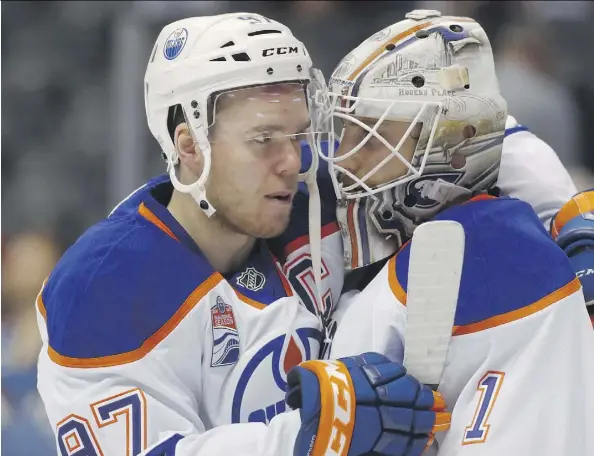  ?? THE ASSOCIATED PRESS ?? Oilers captain Connor McDavid congratula­tes goalie Laurent Brossoit after Thursday’s 7-4 win over the Avalanche in Denver.