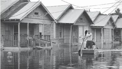  ??  ?? Marine veteran Rocky Damico searches for residents in need of help in the aftermath of Hurricane and Tropical Storm Harvey. The devastatio­n could bring a change in outlook to notoriousl­y regulation-shy Texans.