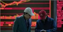  ?? NG HAN GUAN — THE ASSOCIATED PRESS ?? Men chat at a stock brokerage in Beijing, China, Wednesday. Asian stocks were mixed Wednesday after Wall Street declined as President Donald Trump delivered a new warning to North Korea in a speech to South Korean lawmakers.