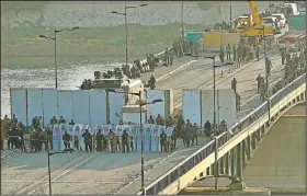  ?? AP/HADI MIZBAN ?? Security forces close a bridge leading to Baghdad’s Green Zone during a protest Saturday.