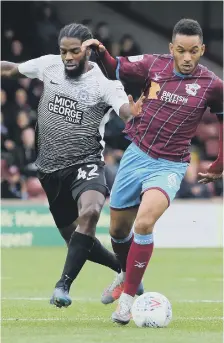  ??  ?? Anthony Grant battles for possession at Scunthorpe.