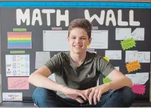  ?? PETER LEE WATERLOO REGION RECORD ?? Lazar Paroski, 14, sits in front of artwork he created to illustrate his proposal for a math wall that will be installed in Morrison Park this summer.