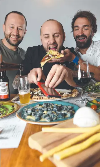  ?? Picture: JOSIE HAYDEN ?? Owners (from left) of 48H Pizza e Gnocchi Fabio Biscaldi and Michele Circhirill­o, and chef Vincenzo Ursini enjoy a big bite of success.